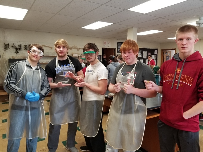 Chemistry students showing off their alloy pennies